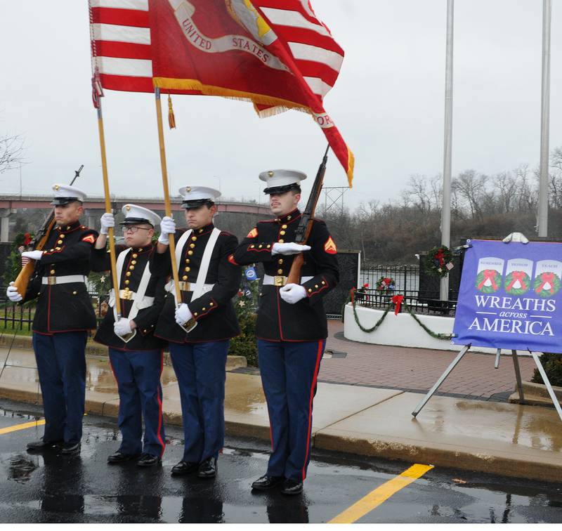 The U.S. Marine Corps Color Guard and Honor Guard post the colors Saturday at the Middle East Conflicts Wall in Marseilles. The Wreaths Across America was one of over 4,000 such events took place across the country honoring veterans.