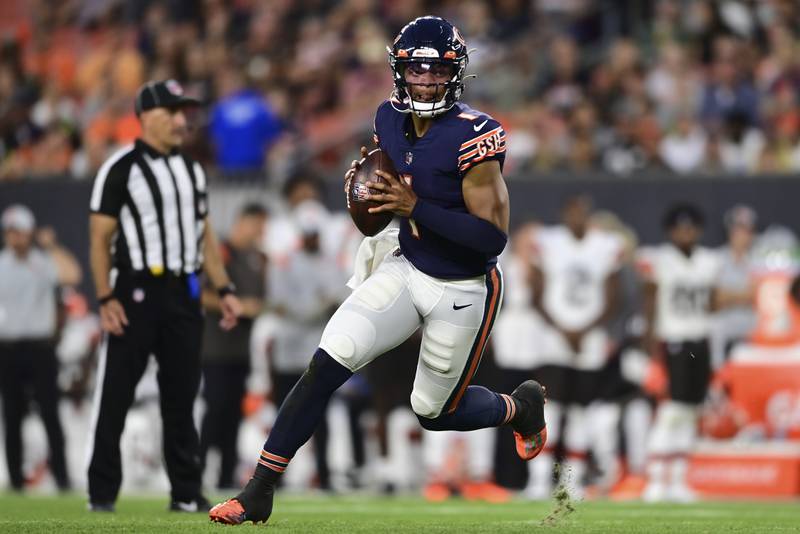 Chicago Bears quarterback Justin Fields scrambles against the Cleveland Browns during the first half, Saturday, Aug. 27, 2022, in Cleveland.