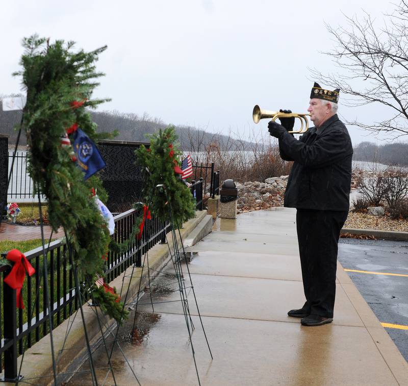 Glenn Borvansky of the Marseilles VFW Post 5506 and American Legion Post 2235 , plays taps concluding the Wreaths Across America ceremony Saturday at the Middle East Conflicts Wall in Marseilles. The Wreaths Across America was one of over 4,000 such events took place across the country honoring veterans.