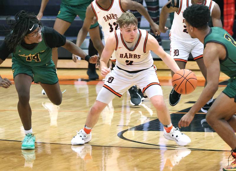 DeKalb’s Sean Reynolds steals the ball and heads up court between two Waubonsie Valley players during their game Friday, Dec. 15, 2023, at DeKalb High School.